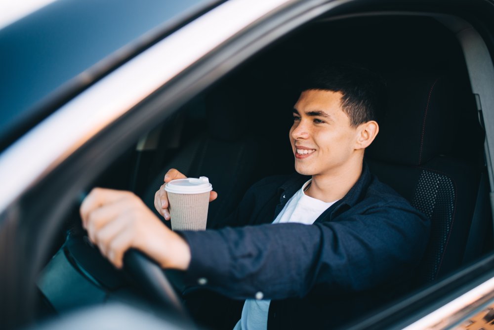 Close,Up,Of,A,Smiling,Businessman,Driving,A,Car,While